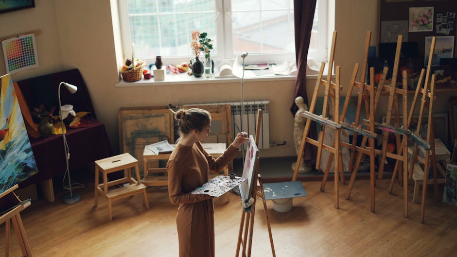 Woman painting in a sunlit art studio, artistic and serene.